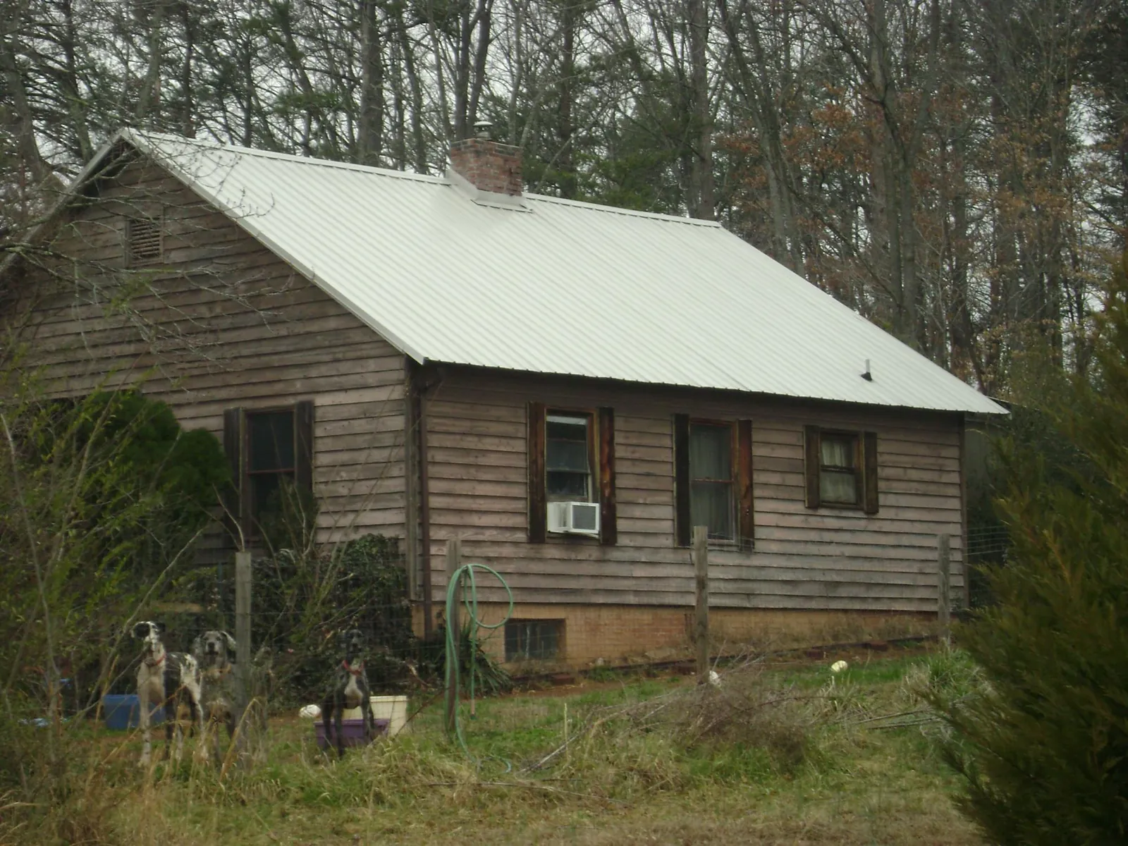 White metal roof on an old wood sided farmhouse, from a Metal Roof Installation job in Robeline
